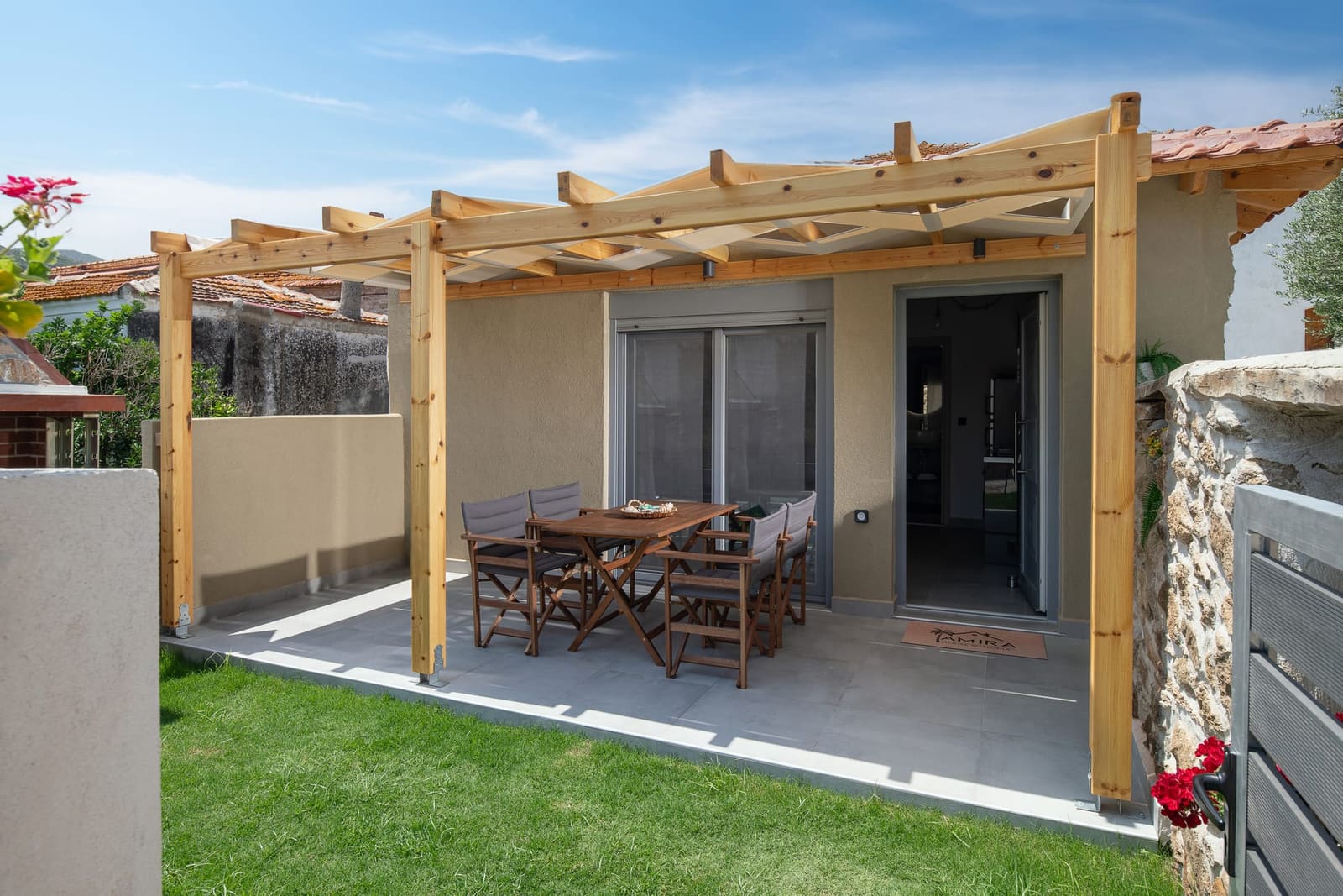 Outdoor dining table under the pergola in the garden of Amira House, Sykia Sithonia
