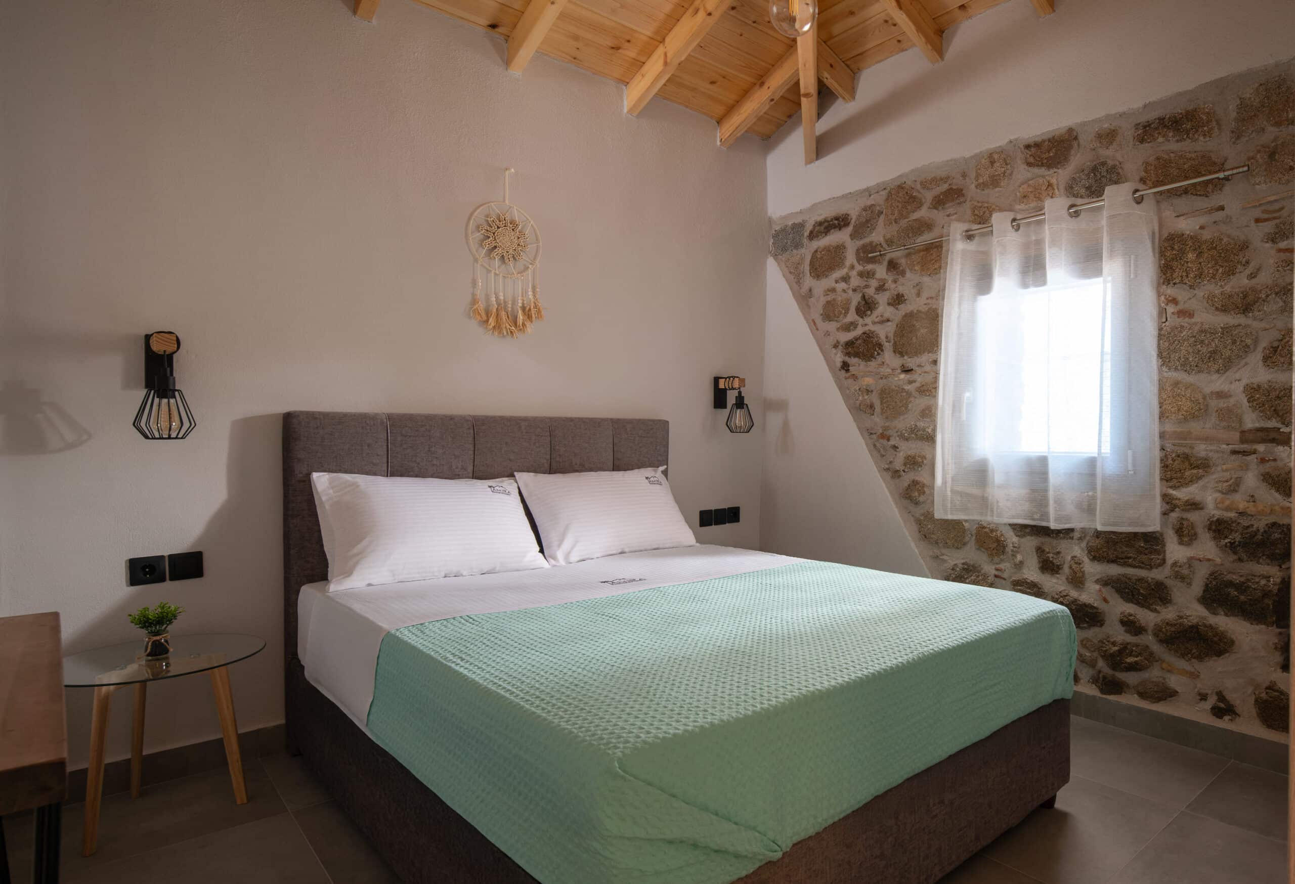 amira-house-sykia-wood-beam-stone-wall